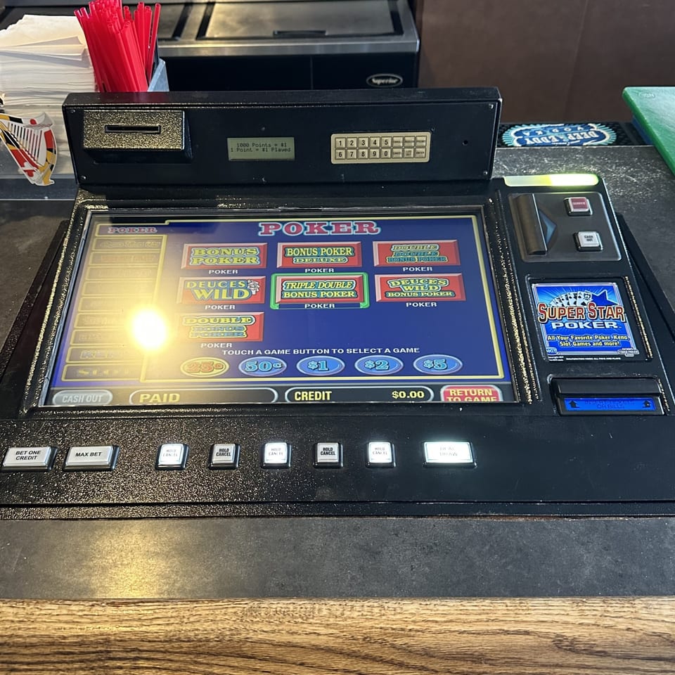 A close-up of a Super Star Poker video game machine at Legends Grill Sports & Spirits.