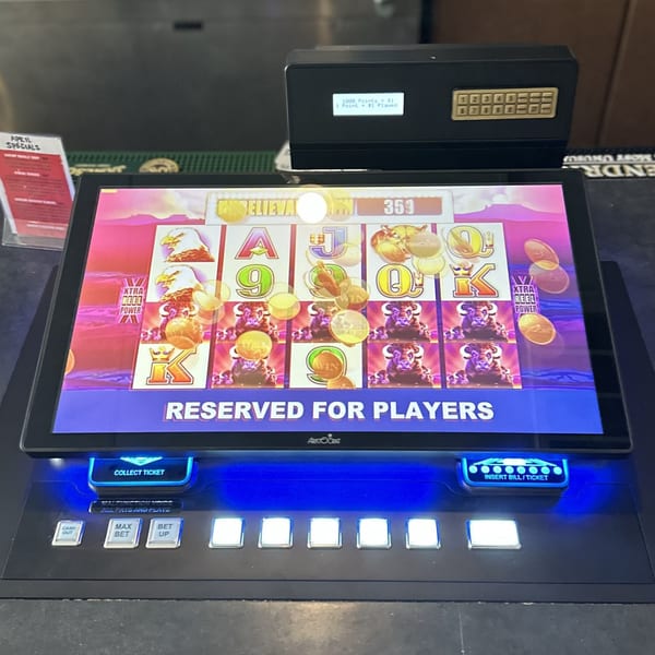 A slot machine with a colorful game screen and control buttons, labeled "Reserved for Players".